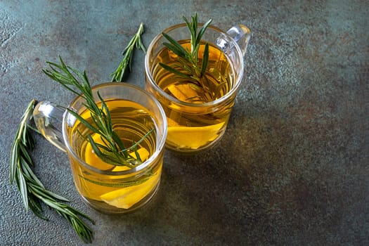 Rosemary tea in two glass cups. Healthy nutrition, alternative and traditional medicine. Selective focus.