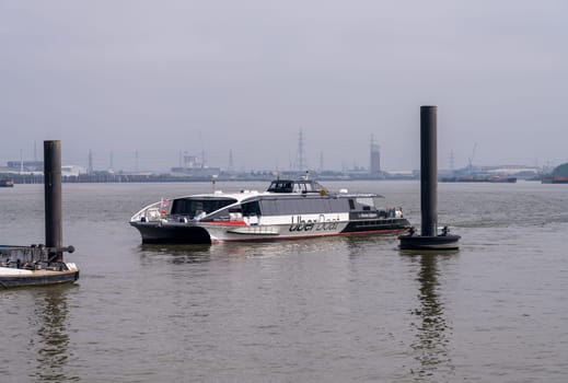 Woolwich, London - 14 May 2023: UberBoat by Thames Clipper docking at pier in Royal Arsenal