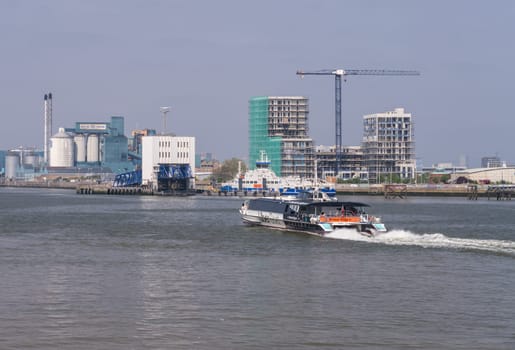 Woolwich, London - 14 May 2023: UberBoat by Thames Clipper speeding towards Woolwich Ferry terminal on Thames
