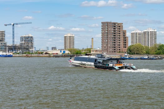 Woolwich, London - 15 May 2023: UberBoat by Thames Clipper speeding towards Woolwich Ferry terminal on Thames