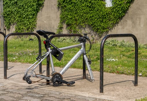 Woolwich, London - 14 May 2023: Quality bike frame locked to cycle stand but missing both wheels