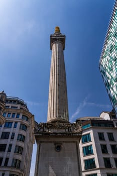 Modern architecture of offices surround the Monument to Great Fire of London