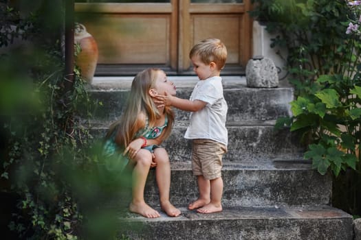 happy sister and brother together in the summer yard