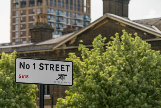 Antique cannon on street sign in Royal Arsenal Riverside development