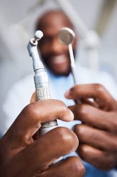 Did someone order a teeth cleaning. Portrait of a young man holding teeth cleaning tools in his dentists office