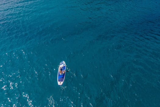 Young women Having Fun Stand Up Paddling in blue water sea near st stefan island in Montenegro. SUP.