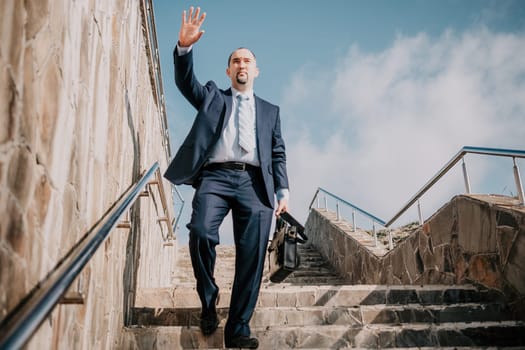 Business executive with briefcase going down the stairs.