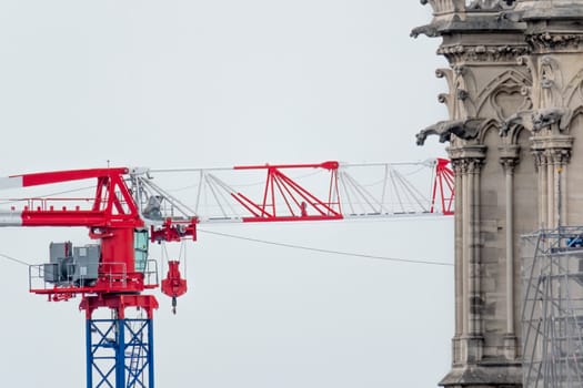 6 May 2023. Paris, France. Work continues on Notre Dame cathedral in preparation for the 2024 Olympics games. A construction crane is seen behind a tower with gargoyles at Notre Dame cathedral after the tragic fire in 2019