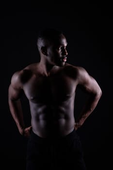 Muscle, body and skin, portrait of black man on dark background with serious face art aesthetic.