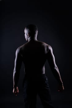 Muscle, body and skin, portrait of black man on dark background with serious face art aesthetic.