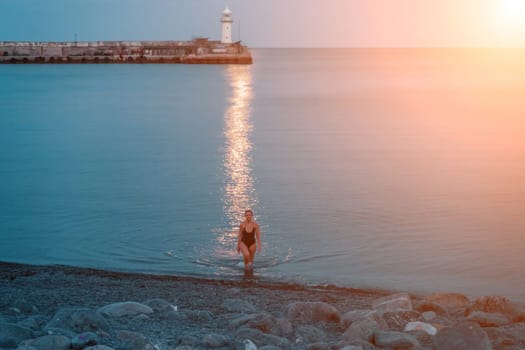 Woman The full moon rises to the lighthouse, the lunar path along the sea leads to the woman