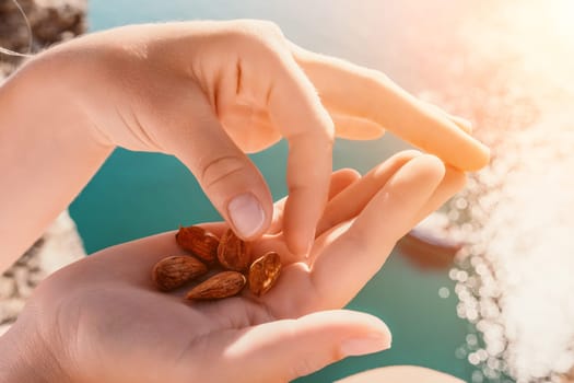 Unrecognizable caucasian woman eating young milky almond nuts. Healthy vegan food