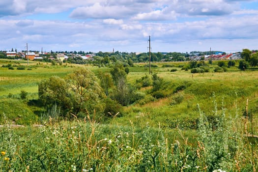 an area of open land, especially one planted with crops or pasture, typically bounded by hedges or fences