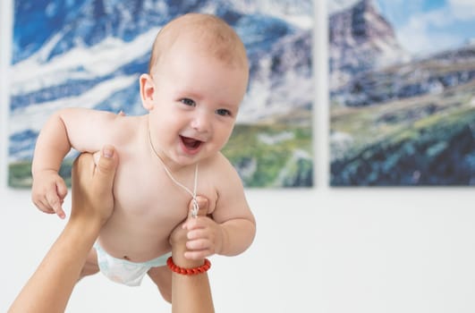 picture of happy mother with baby in hands.