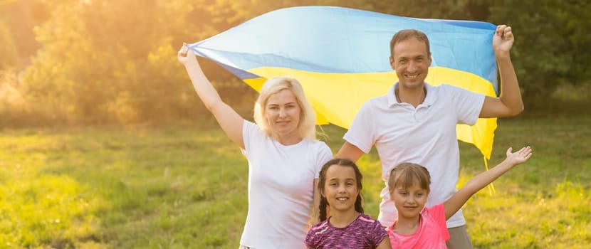 happy family with flag of ukraine in field. lifestyle.