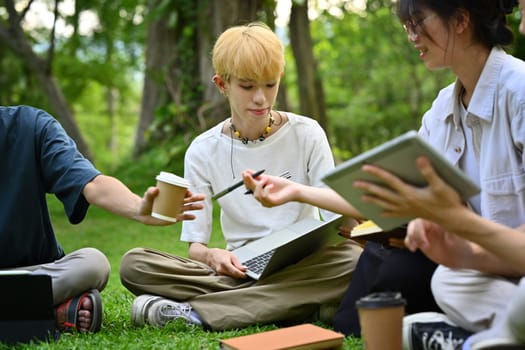 Shot of university students doing group project together in university campus. Education and youth lifestyle concept.