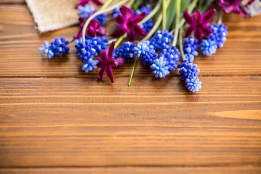 beautiful bouquet of spring flowers on a wooden table, rustic style.