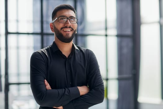 Businessman portrait. Happy confident young businessman standing , smiling, looking at camera.