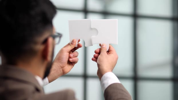 businessman show white jigsaw in hand, business strategy concept