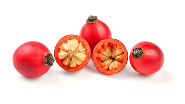 Rosehips ( Rosa Canina fruits), one cut in half isolated on white background.