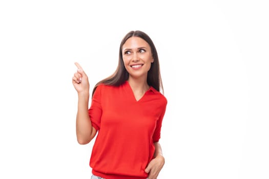 young smiling european woman with dark straight hair dressed in a red short sleeve shirt on a white background with copy space.
