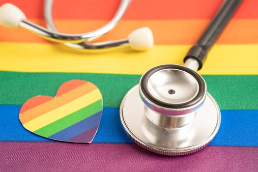 Black stethoscope on rainbow flag with heart, symbol of LGBT pride month celebrate annual in June social, symbol of gay, lesbian, bisexual, transgender, human rights and peace.