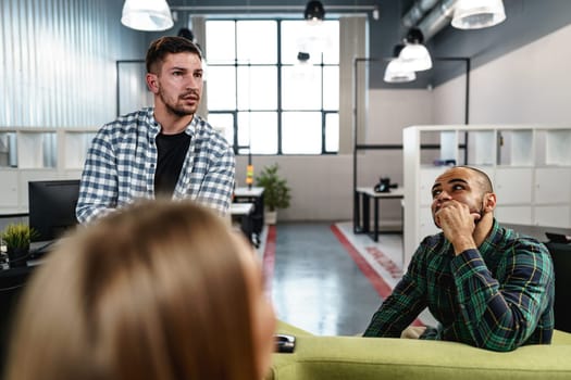 Two young men working together on a new business project in office, close up