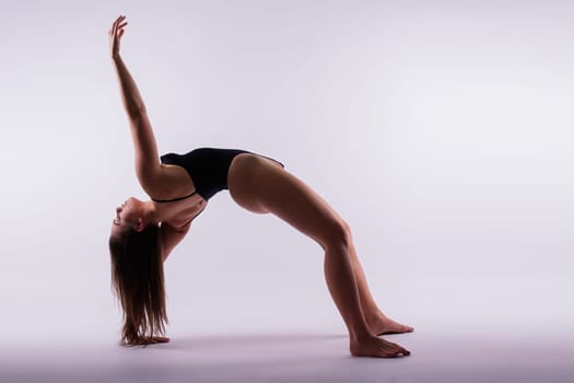 Beautiful woman doing poses on a yoga class. Studio shot.