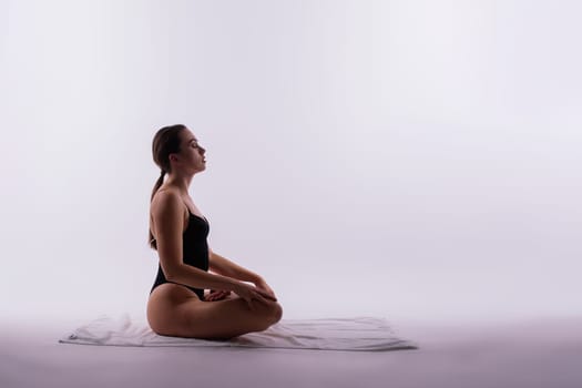 Beautiful woman doing poses on a yoga class. Studio shot.