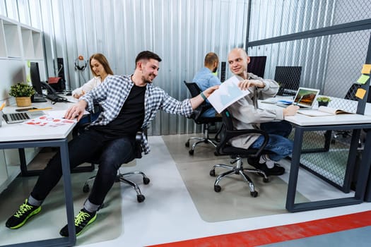 Group of young business people working in modern office together