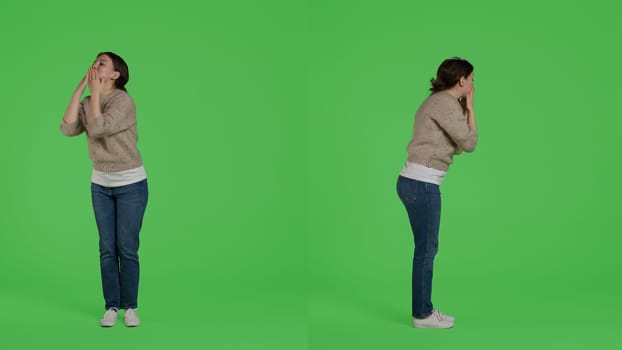Confident lovely woman blowing air kisses and acting romantic, being positive and optimistic in studio. Young person spreading love and beautiful feelings on greenscreen backdrop.
