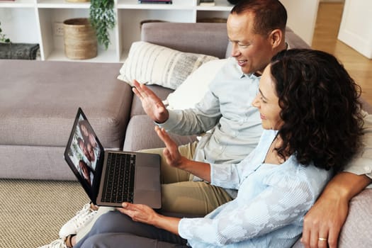 Couple, laptop and wave for video call on home sofa for communication and network connection. Man and woman in living room with technology for virtual conversation hello during distance family chat.