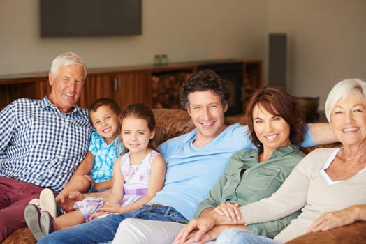 Family is lifes greatest blessing. a happy multi-generational family sitting together on a sofa