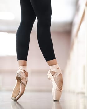 Close-up but ballerinas in pointe shoes in a dance class