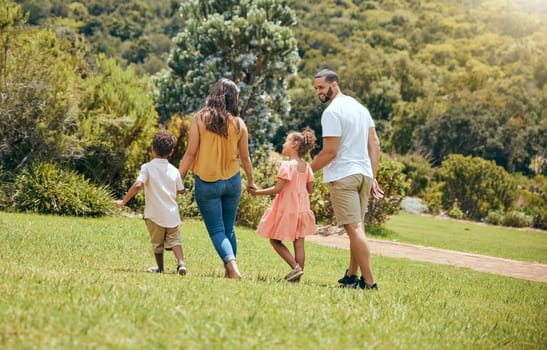 Family, kids and walking in the park for bonding, fun and care in summer outside. Mother, father and parents playfully walk with children, son and daughter siblings in a garden for bond.