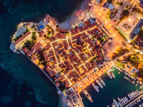 Budva city lights from Montenegro seen from above. Night view. Drone old town Budva at night.