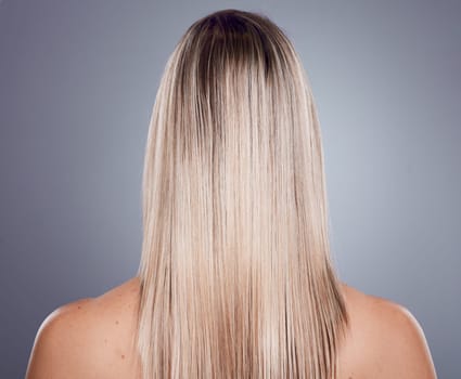 Hair care, blonde woman and back view of natural beauty, keratin texture and beauty salon cosmetics on studio background. Model, long hairstyle and scalp treatment for shine, glow and healthy shampoo.