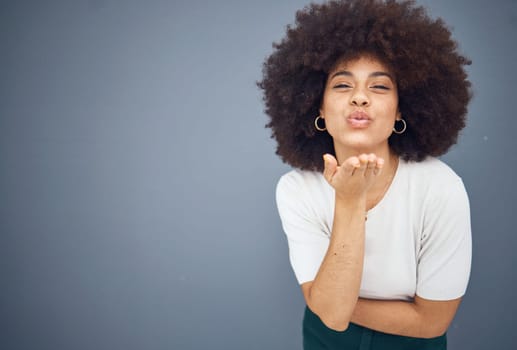 Blow kiss, black woman and mockup showing love, smile and happy kissing with beauty. Model from New York with natural hair, happiness and mock up space loving romance and skincare wellness in studio.