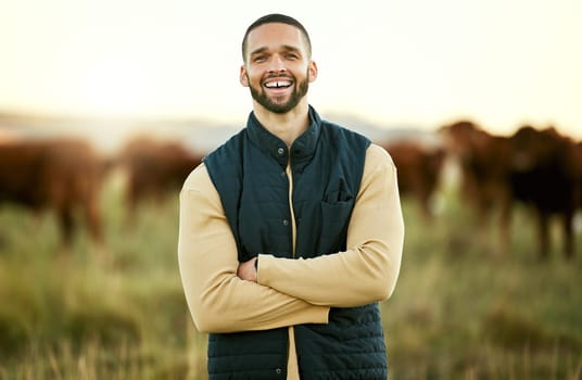 Smile, cow and agriculture with man on farm for sustainability, production and cattle. Livestock, arms crossed and management with portrait of farmer on countryside field for dairy, animals and care.