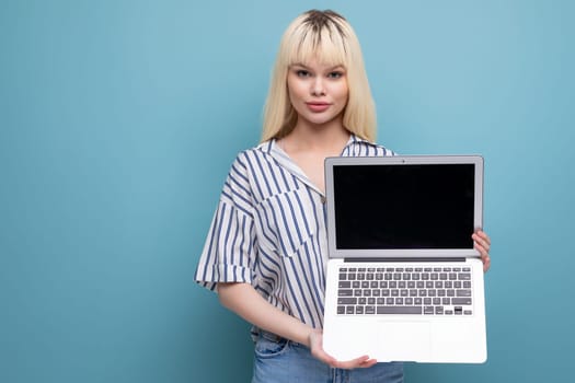 smart blonde young female adult in blouse demonstrates laptop screen for advertising isolated background.