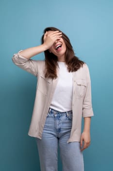 smiling caucasian young brunette woman in shirt and jeans.