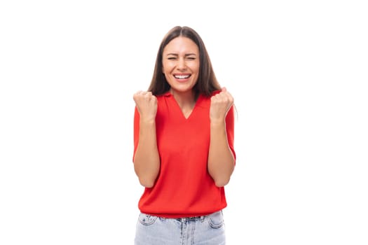 a young European woman with dark straight hair wearing a red short-sleeved shirt actively gestures and uses facial expressions.