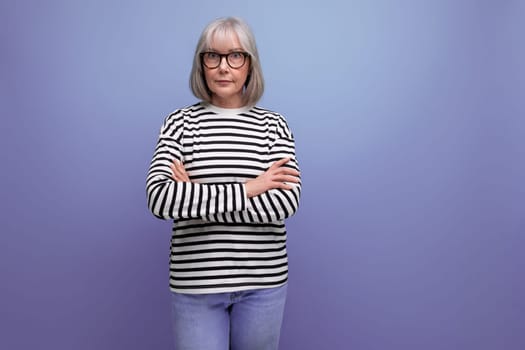 portrait of an old woman with gray hair in a fashionable image on a bright studio background.