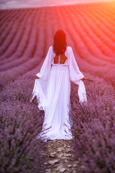 Woman lavender field. Lavender field happy woman in white dress in lavender field summer time at sunset.