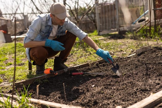 man planting crops in garden