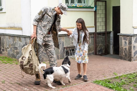 Happy little girl having fun with her military father.