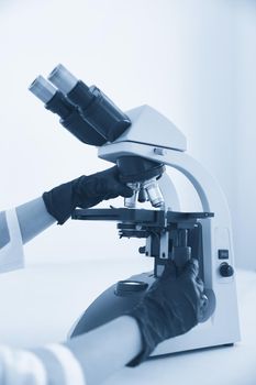 scientist hands with microscope, examining samples