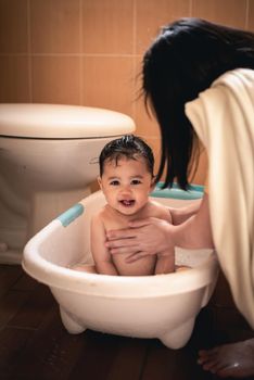 cute baby taking a shower with her mom