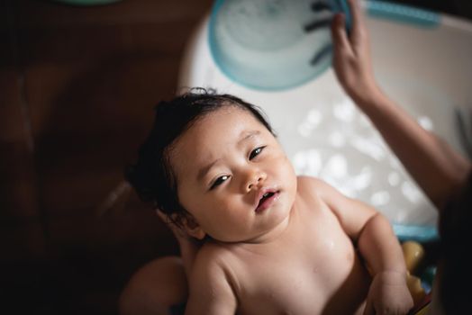 cute baby taking a shower with her mom