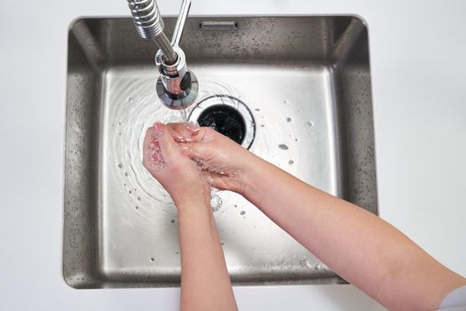 Woman washing hands with antibacterial soap for corona virus prevention, hygiene to stop spreading coronavirus covid19